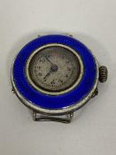 An Edwardian silver wristwatch, lacking strap with guilloche border to dial, interior with maker's