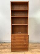 Hundevad, a mid century Danish teak bookcase on chest, fitted with three adjustable shelves and four