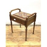 An early 20th century mahogany piano stool, with hinged needlework upholstered seat, raised on