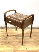 An early 20th century mahogany piano stool, with hinged needlework upholstered seat, raised on