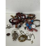 A mixed lot of jewellery including a 9ct gold crucifix (2.5cm) (0.6g), polished stone necklaces,