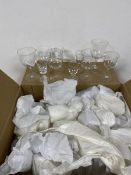 A quantity of drinking glasses including wine glasses, sherry glasses, most wrapped (a lot)