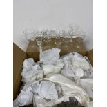 A quantity of drinking glasses including wine glasses, sherry glasses, most wrapped (a lot)