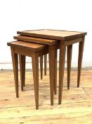 A Vintage mid century teak nest of three tables, the rectangular tops raised on square tapered