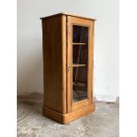 A Victorian pine glazed door cabinet, with two shelves, on a plinth base, H92cm, W45cm, D34cm