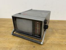A Binatone Grand Prix five inch black and white portable television (13cm x 19cm x 25cm)