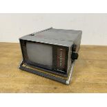 A Binatone Grand Prix five inch black and white portable television (13cm x 19cm x 25cm)