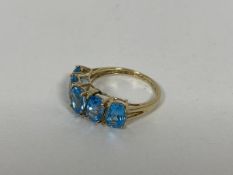 A 9ct gold ring set five oval cut light blue stones (P) (2.75g)