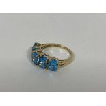 A 9ct gold ring set five oval cut light blue stones (P) (2.75g)