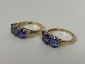 Two 9ct gold dress rings, both set three oval cut blue/purple stones flanked by chip diamonds (O/