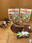 A mixed lot including two Wombles annuals 1976 books, a carved hardwood horse, marble solitaire game