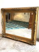 A Large gilt composition framed wall hanging mirror, of 18th century design, the frame decorated