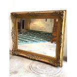 A Large gilt composition framed wall hanging mirror, of 18th century design, the frame decorated