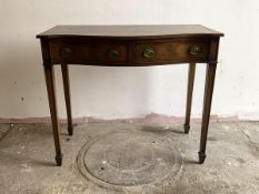 A cross banded mahogany serpentine serving table in the Regency taste, with a drawer and a fitted