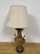 A gilt metal table lamp of rococo inspired form, on marble base and bun feet (a/f) (62cm to top of