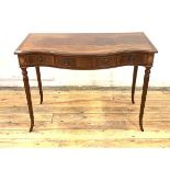 A Regency style inlaid mahogany console table of serpentine outline, the cross banded top with