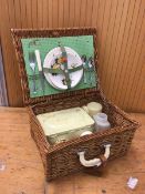 A vintage picnic basket includes two plates, two teacups and saucers, knife, fork etc (a/f) measures