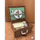 A vintage picnic basket includes two plates, two teacups and saucers, knife, fork etc (a/f) measures