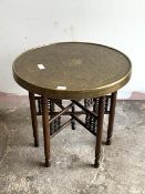 An early 20th century eastern brass tray topped occasional table, raised on turned supports united