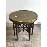 An early 20th century eastern brass tray topped occasional table, raised on turned supports united