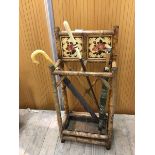 A late 19thc cane and tile umbrella stand with two divisions over drip tray along with two