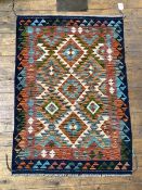 A Chobi Kilim rug of all over lozenge and geometric design within a running dog border, 141cm x