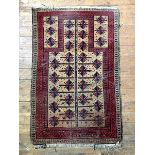An old Baluchi prayer rug, central mihrab panel enclosed by geometric design to border, 144cm x