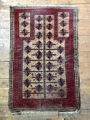 An old Baluchi prayer rug, central mihrab panel enclosed by geometric design to border, 144cm x