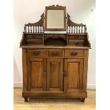 An early 20th century walnut dressing chest, the top fitted with swing mirror and trinket drawers