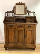 An early 20th century walnut dressing chest, the top fitted with swing mirror and trinket drawers