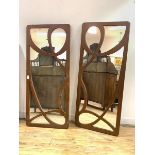 A Pair of wall hanging mirrors of Art Nouveau design with the fret cut painted frames 65cm x 151cm