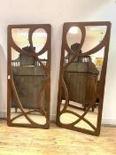 A Pair of wall hanging mirrors of Art Nouveau design with the fret cut painted frames 65cm x 151cm