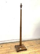 A walnut standard lamp, circa 1940, the square tapered column on a stepped square base with