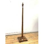 A walnut standard lamp, circa 1940, the square tapered column on a stepped square base with