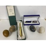 Two Waterman pens in original presentation box, a brass cricket bat (16cm) and four polished stone