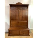 A French cherrywood hall stand, the panelled raised back with open shelf and four coat hooks, over