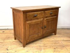 A hardwood sideboard, the moulded rectangular top over two drawers, with twin panelled doors to