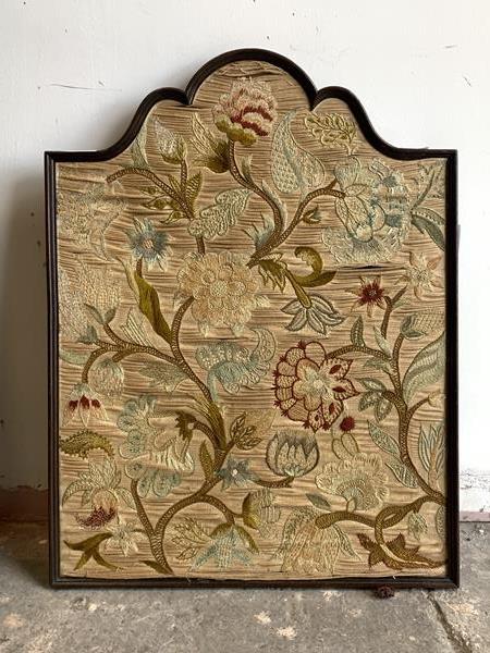 An early 20th century embroidered panel, in an arched frame with textile to reverse, 53cm x 69cm