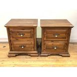 A Pair of hardwood bedside chests, each fitted with two drawers, raised on shaped block supports,