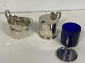 A 1915 Birmingham silver small milk jug (6cm) and an 1882 London silver condiment pot with blue