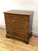 A Georgian style mahogany chest, the rosewood cross banded top over four graduated drawers, raised