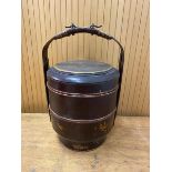 A Chinese food carrier with fixed handle and painted decoration measures 40cm high