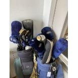 A collection of golf clubs including woods such as a Hippo Beast Driver, Arizona Golf Co. three