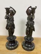 A pair of spelter figures of female water carriers with stone bases (a/f) measures 37cm high