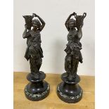 A pair of spelter figures of female water carriers with stone bases (a/f) measures 37cm high