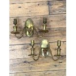 A pair of early 20th century cast brass two branch wall sconces, together with decorative shades,