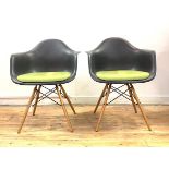 Vitra Eames, A pair of DAW chairs, with moulded and upholstered seat, raised on turned supports