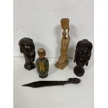 A pair of carved African hardwood busts, one male, one female, another sculpture of a Kneeling Woman