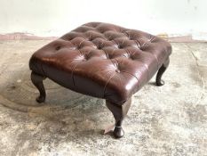 A footstool, upholstered in buttoned and studded oxblood leather, raised on cabriole supports,