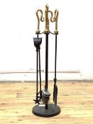 A brass and iron four piece fireside companion set, H67cm